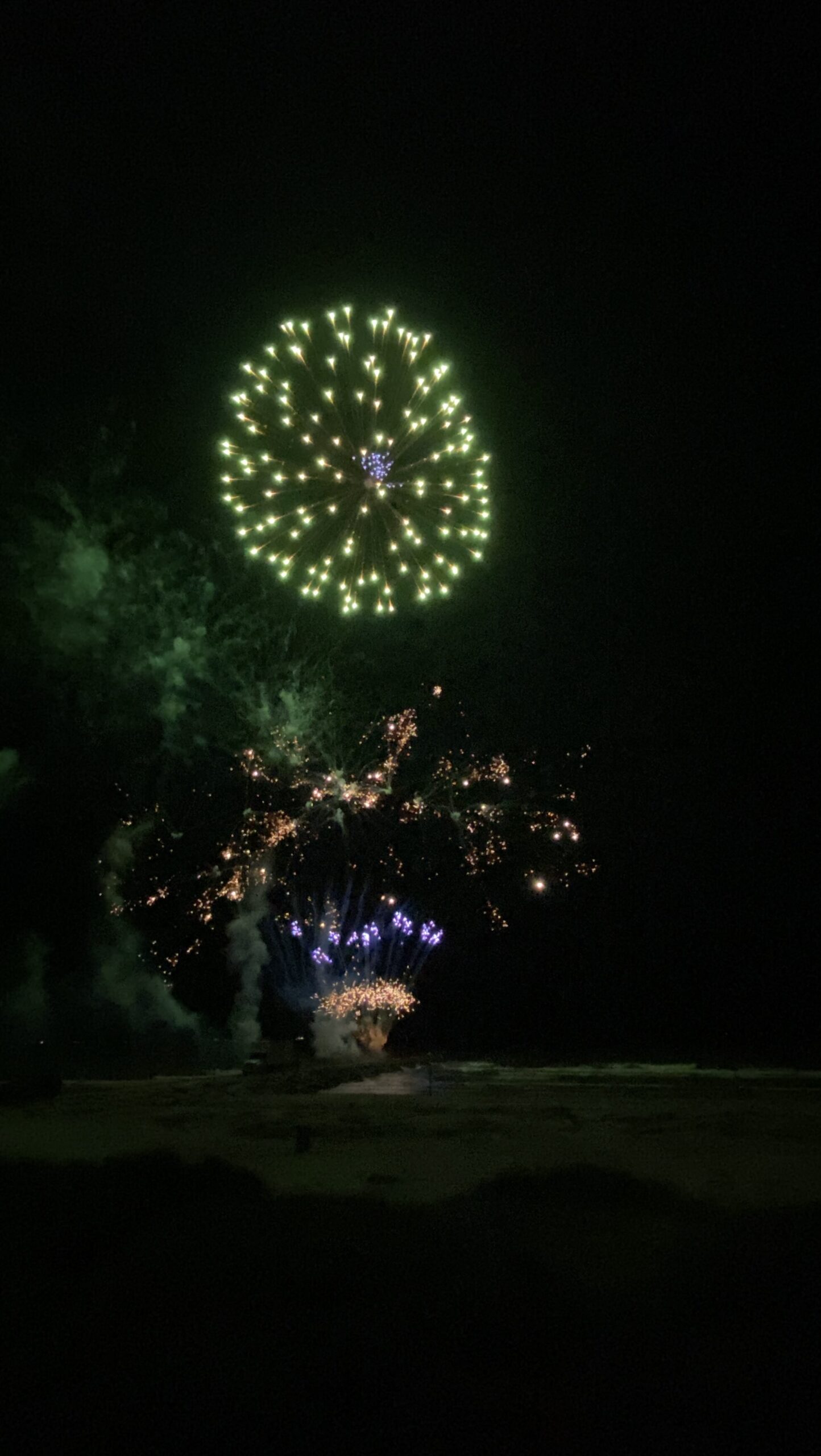 Brilliant fireworks illuminating Galveston Harbor and Victorian architecture