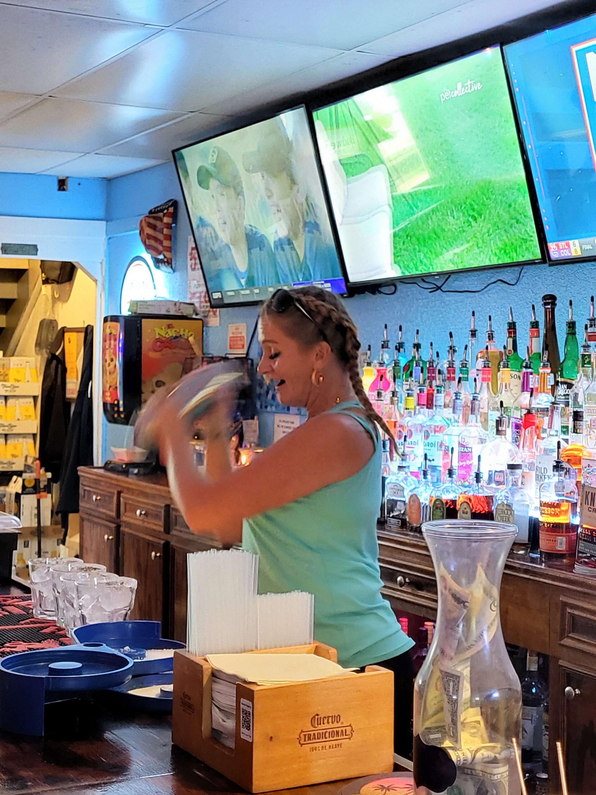 Female mixologist shaking craft cocktail on Galveston tour